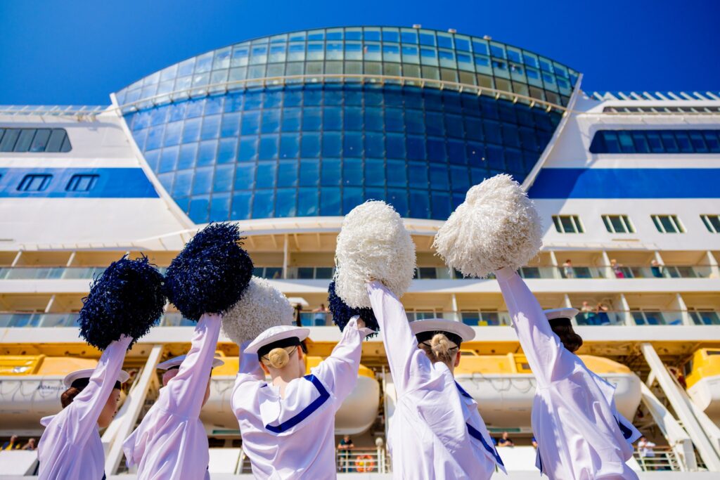 AIDAbella in Hamina June 2025, parade girls waving their pom-poms welcoming the passengers